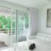 Le Cameleon Boutique Hotel in Puerto Viejo de Talamanca: white suite with balcony and tropical garden view