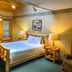 Ruttger's Bay Lake Resort room in Deerwood with wooden bed, lake-view window, and sitting area