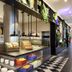 citizenM Austin Downtown buffet station with fruit, pastries and hanging pendant lights in Austin