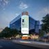 Beijing Hwa Apartment Hotel in Beijing exterior at dusk with glass facade and city street view