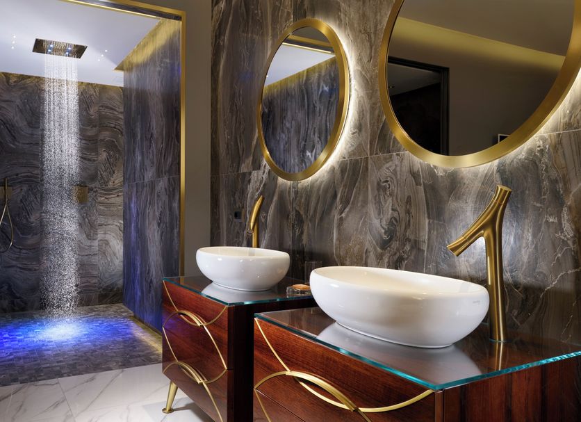Riva del Sole Resort & Spa bathroom with double vessel sinks and marble shower in Castiglione della Pescaia