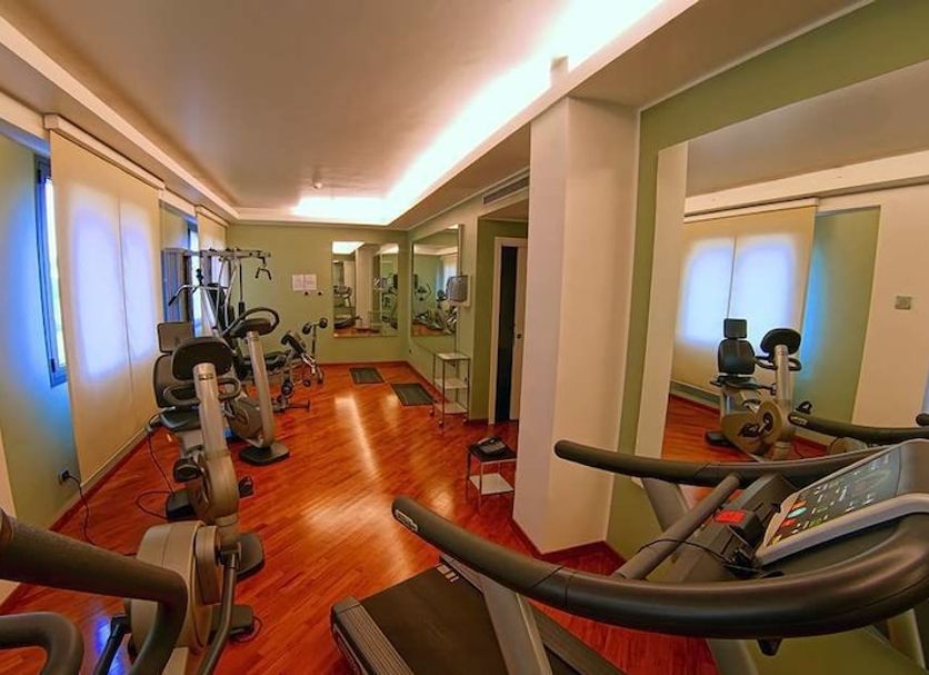 Hotel Sporting Cologno gym with treadmills, exercise bikes and mirrors in Cologno Monzese