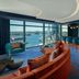 W Sydney in Sydney bar lounge with harbor view, floor-to-ceiling windows, and colorful seating