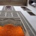 La Maison Bleue Batha in Fez features ornate carved Moorish arches and intricate tilework