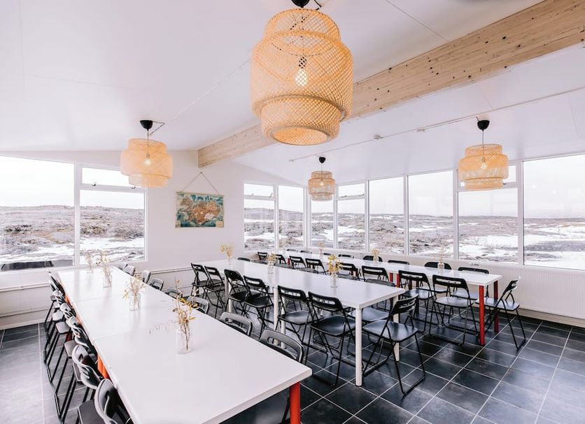 Hlid Hostel in Reykjahlid dining room with long tables and panoramic lake or lava field views