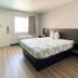 Motel 6 Costa Mesa guest room with king bed, desk, and window seating