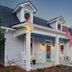 Aerie Bed & Breakfast in New Bern with a front porch, white rocking chairs, and holiday wreaths