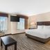 Best Western Plus Valdosta Hotel & Suites room with king bed, sofa, TV and city view in Valdosta