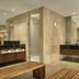 JW Marriott Hotel Bogota spa changing area in Bogotá with benches, sinks, and stone-tiled walls