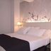 Hotel Mediterrani in Calella de Palafrugell guest room with double bed, bedside lamps and floral headboard