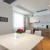 Una Hotels Le Terrazze Treviso Hotel & Residence in Villorba kitchen-dining area with white table and modern cabinets