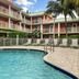 Club Wyndham Sea Gardens in Pompano Beach with a courtyard pool and palm trees