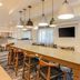 Fairfield Inn & Suites by Marriott Houston Westchase breakfast area with communal table and pendant lights