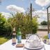 Hotel - Restaurant du Lac - Agen lakeside terrace table set for dining with garden and water view in Boé