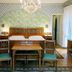 Hotel De La Poste in Cortina d'Ampezzo bedroom with chandelier, twin beds, wardrobe and vanity