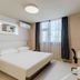 Jinjiang Inn (Huizhou Dadao Hefei) guest room in Hefei with double bed, desk, and window with curtains