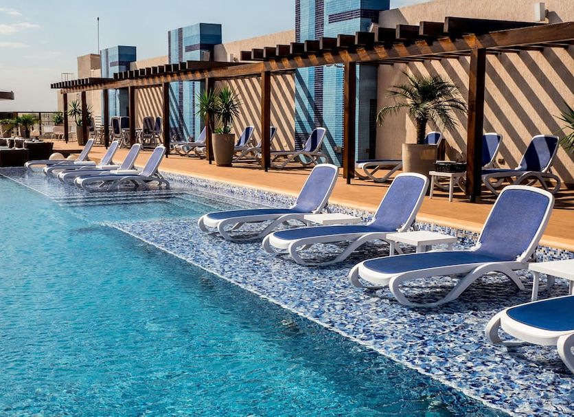 Rooftop pool with lounge chairs at Gran Bourbon Hotel Asuncion in Asuncion