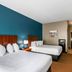 The Hotel Saratoga, an Ascend Collection Hotel in Saratoga Springs, guest room with two beds and teal accent wall