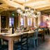 Chalet-Hôtel La Marmotte, La Tapiaz & Spa in Les Gets: rustic wood dining room with chandelier and long table
