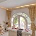 Club Mahindra Emerald Palms, Goa spa treatment room with massage table and arched window in Varca