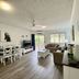 Cairns Beach Resort Holloways Beach apartment living and dining area with balcony view
