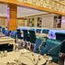 Rota Bulvar Hotel in Ankara restaurant with teal chairs, set tables and a bar counter