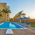 Poolside view at City Express by Marriott Lazaro Cardenas in Lazaro Cardenas with palm trees and blue loungers