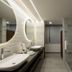 Origen 438 Luxury Boutique Hotel in Guadalajara bathroom with double sinks, lit mirror and glass shower