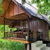 Seashell Resort Hostel Koh Tao bungalow with wooden porch amid tropical greenery in Ko Tao