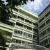 Florida Hotel Bangkok exterior of green mid-rise buildings with courtyard view and cloudy sky