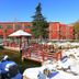 Jinan Jier Hotel in Jinan with red buildings, snowy garden, pond, and covered bridge