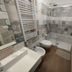 Domatia Barletta bathroom with walk-in shower, bidet, towel radiator and patterned tile walls