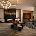 Renaissance Boulder Flatiron Hotel in Broomfield lobby with chandelier, seating area, and decorative railing