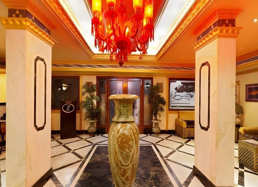 Hotel Ik London Residency Hyderabad lobby with grand chandelier and decorative vase