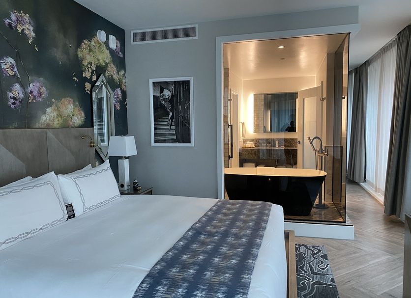 Exchange Hotel Vancouver room with king bed and glass-enclosed soaking tub in Vancouver