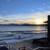 Crown Motel in Kings Beach with lakefront view, sandy shoreline, sunset, and balcony railing