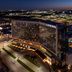 Loews Arlington Hotel at night with illuminated exterior and rooftop pool overlooking Arlington