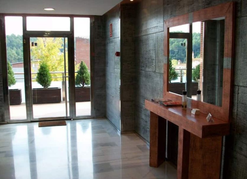 Aparthotel Del Golf in Sant Cugat del Vallès lobby with glass entrance and mirrored console table