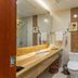 Ordos Tieniu Phoenix Hotel bathroom with vanity, toilet, shower, and mosaic tile accents in Ordos City