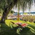 Flairhotel am Wörthersee in Velden am Wörthersee with lakeside lawn, loungers, and Wörthersee view