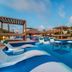 Grand Windsock Bonaire in Kralendijk features a tropical pool with white loungers, pergolas and palm trees.