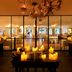 Grand Hôtel De Cala Rossa in Porto-Vecchio, candlelit dining room with chandeliers and glass walls