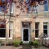 Lochinver Guest House in Ayr, stone guest house exterior with bay windows and flowering tree