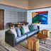 Hard Rock Hotel Maldives suite with sofa, colorful wall art, and patterned rug in Malé