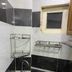 Funny Guesthouse Ho Chi Minh City bathroom sink with black-and-white tiled walls and a small window