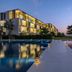 Al Zorah Beach Resort Ajman waterfront pool and illuminated walkway at dusk