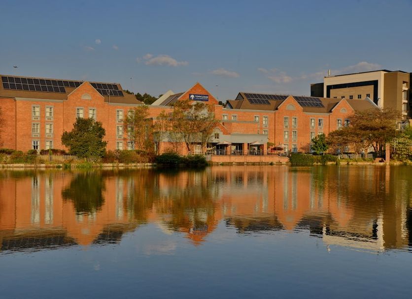 Town Lodge Roodepoort in Roodepoort, with lakeside building reflection at sunset