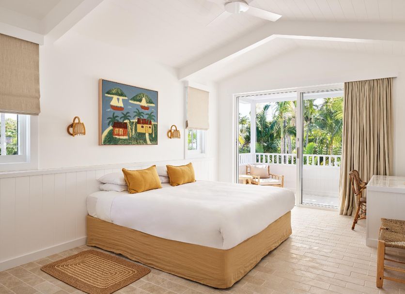 Atlantic Byron Bay room with king bed, tropical artwork, and balcony view in Byron Bay