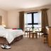 The Lodge At Craigielaw room in Gullane with a double bed, seating by a window, and beige decor