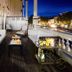 Evening balcony lounge at The Adelphi Hotel in Saratoga Springs with sofas and city views